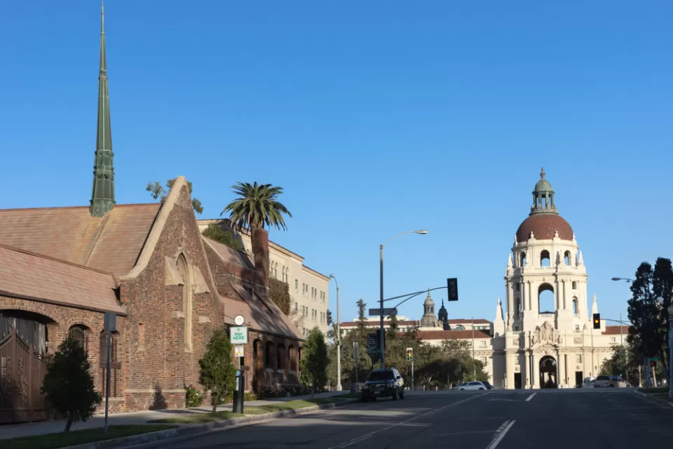 View of street in Pasadena, California with church at left and city hall in background